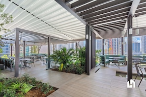 Al fresco dining and lounge areas under stylish pergolas. - Heart of Downtown, Ocean Views & Pool (Miami)
