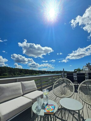 A deck with a sofa, two chairs, a table, and a book titled 'Donald Duck.' - Cabin with views over Hvaler archipelago (Gamle Frederikstad)