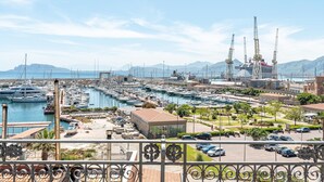 A marina with numerous boats docked, a large ship under construction, and a mountainous backdrop. - Igiea Florio Sea View by Wonderful Italy (Palermo)