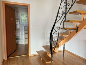 A wooden staircase with a black metal handrail leading to a landing. - Domizil Seeidyll Appartement/Fewo Appartement/Fewo by Interhome (Spiez)
