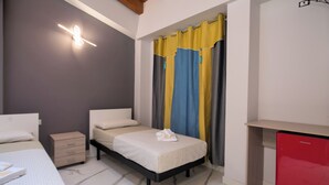 A bedroom with a bed, bedside tables, a wardrobe, and a red appliance. - B&b Villa Ravenna (Ravenna)