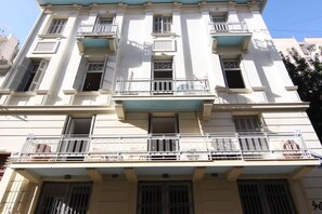 A multi-story building with balconies, windows, and a flat roof. - Zen Amazing, Exarchia (Athens)