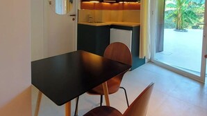A compact kitchen with a dining area, a ceiling light, and a view of greenery outside. - Papaya Suite for 3 guests, located in the nature park, Free parking (Rapallo)