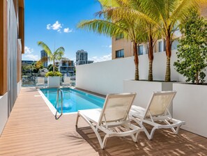 A rooftop pool area with a clear view of the city skyline, including high-rise buildings. - Apt 2 - 18 Remembrance Drive - Surfers Paradise (Surfers Paradise)