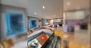 A modern living room with a sofa, coffee table, and a view of the outside. - Stylish and Modern 1BDR in Farringdon London (London)