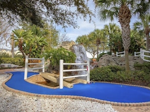 A miniature golf course with a blue putting surface, a rock formation, and a waterfall feature. - 2 Bedroom Villa at Harbour Lake Family-Friendly (Orlando)