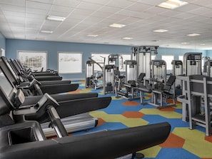A gym with treadmills, weight machines, and a colorful hexagonal carpet. - 2 Bedroom Villa at Harbour Lake Family-Friendly (Orlando)