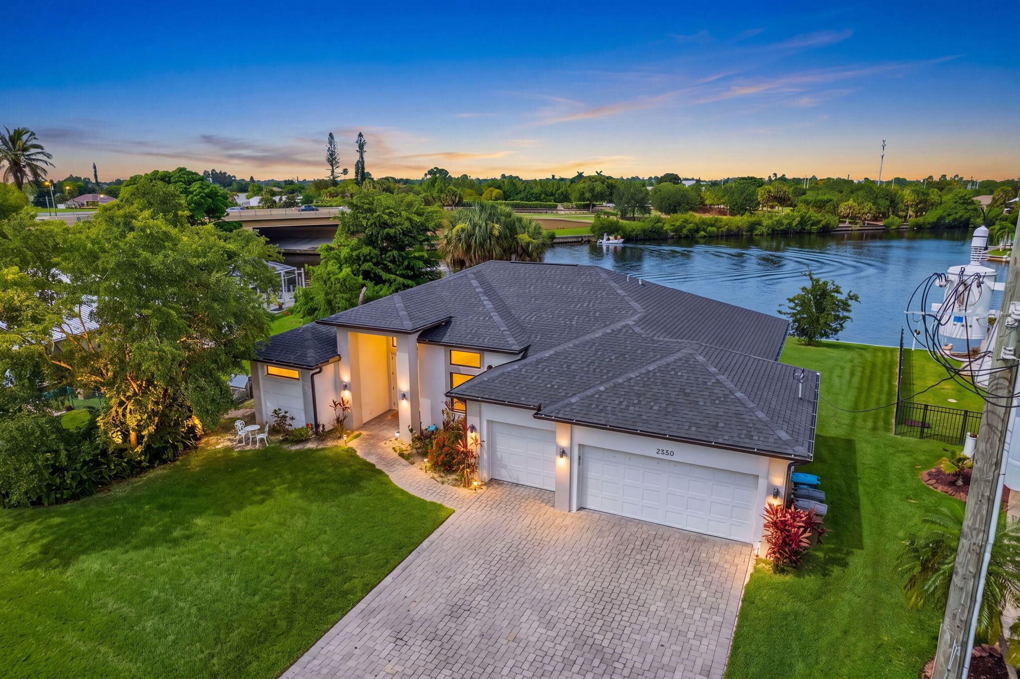 A two-story house with a garage, a driveway, and a well-maintained lawn.