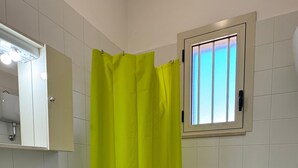 Ein Badezimmer mit Waschbecken, Toilette und Duschvorhang.