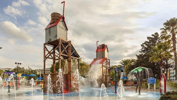 A water park with multiple water fountains and a wooden structure with a red roof. - 1 Bedroom Villa at Harbour Lake Family-Friendly (ORLANDO)