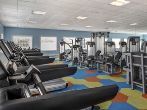 A gym with treadmills, weight machines, and a colorful hexagonal carpet. - 1 Bedroom Villa at Harbour Lake Family-Friendly (ORLANDO)