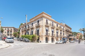 A multi-story building with a classical architectural style, featuring balconies and a central entrance. - Igiea Florio Sea View Apartments by Wonderful Italy (Palermo)
