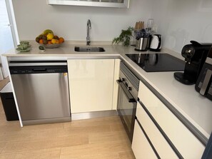 A modern kitchen with a dishwasher, oven, and coffee maker. - Groundfloor Zenia Beach La Zenia (Orihuela)