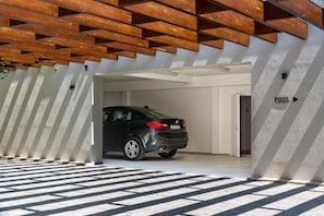A modern parking garage with a BMW parked inside.