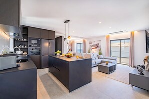 A modern kitchen with built-in appliances and a central island.