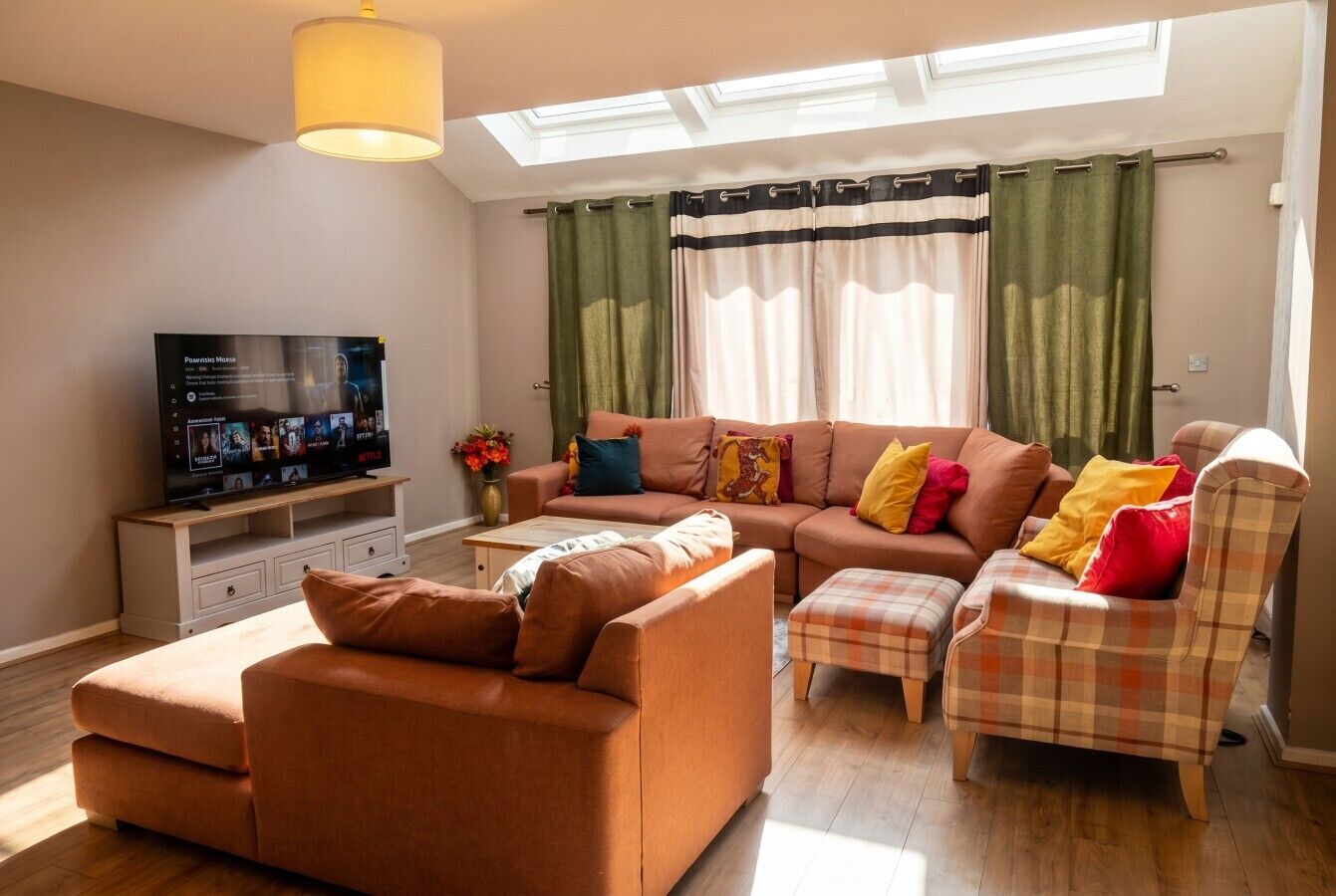 A living room with a sofa set, a television, and a coffee table.