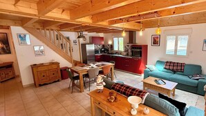 A cozy interior with a dining area, sofa, and kitchen. - La Pergola Le Mont Dore (6 people) (Mont-Dore)