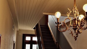 Una escalera con barandal de madera y suelo estampado.