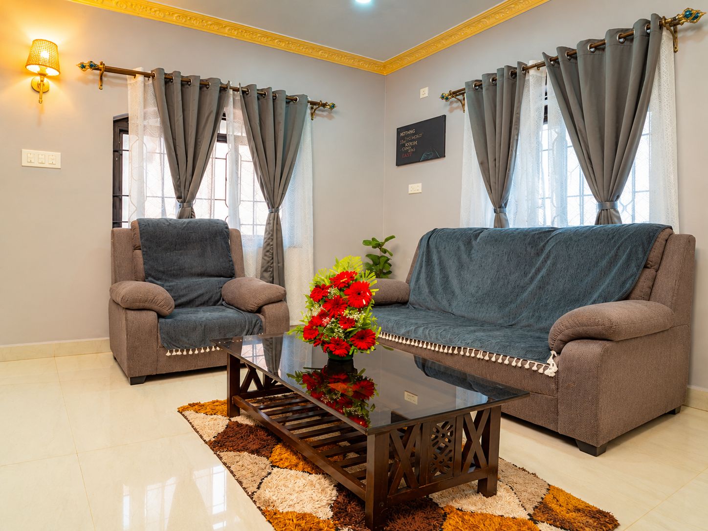 A living room with two sofas, a coffee table, and a decorative lamp.
