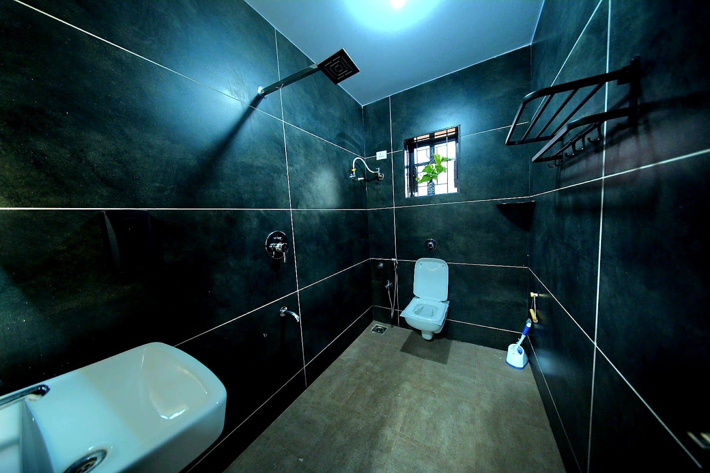 A bathroom with a toilet, a sink, and a shower.