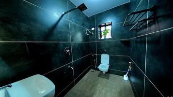 A bathroom with a toilet, a sink, and a shower.