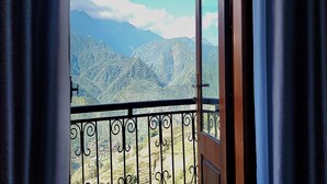 A balcony with a wrought iron railing overlooking a mountainous landscape. - Mountain View Homestay SaPa (Sa Pa)