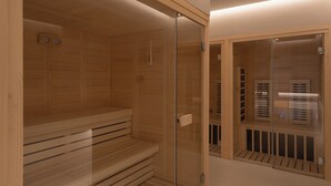 A sauna room with wooden walls and a glass door. - The George Athens (Athens)