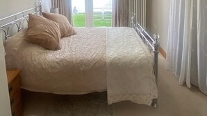 A bedroom with a bed, a skylight, curtains, and a view of the outdoors. - Moss Retreat Sleeps 2, Balcony/garden/parking/pubs (Nantwich)