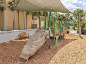 A playground with a slide, climbing structures, and a bench. - 3 Bedroom Villa at Marriott Imperial Palms Resort (, Orlando)
