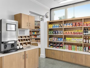A kitchenette with a coffee machine, shelves stocked with snacks, and a view through a window. - 3 Bedroom Villa at Marriott Imperial Palms Resort (, Orlando)