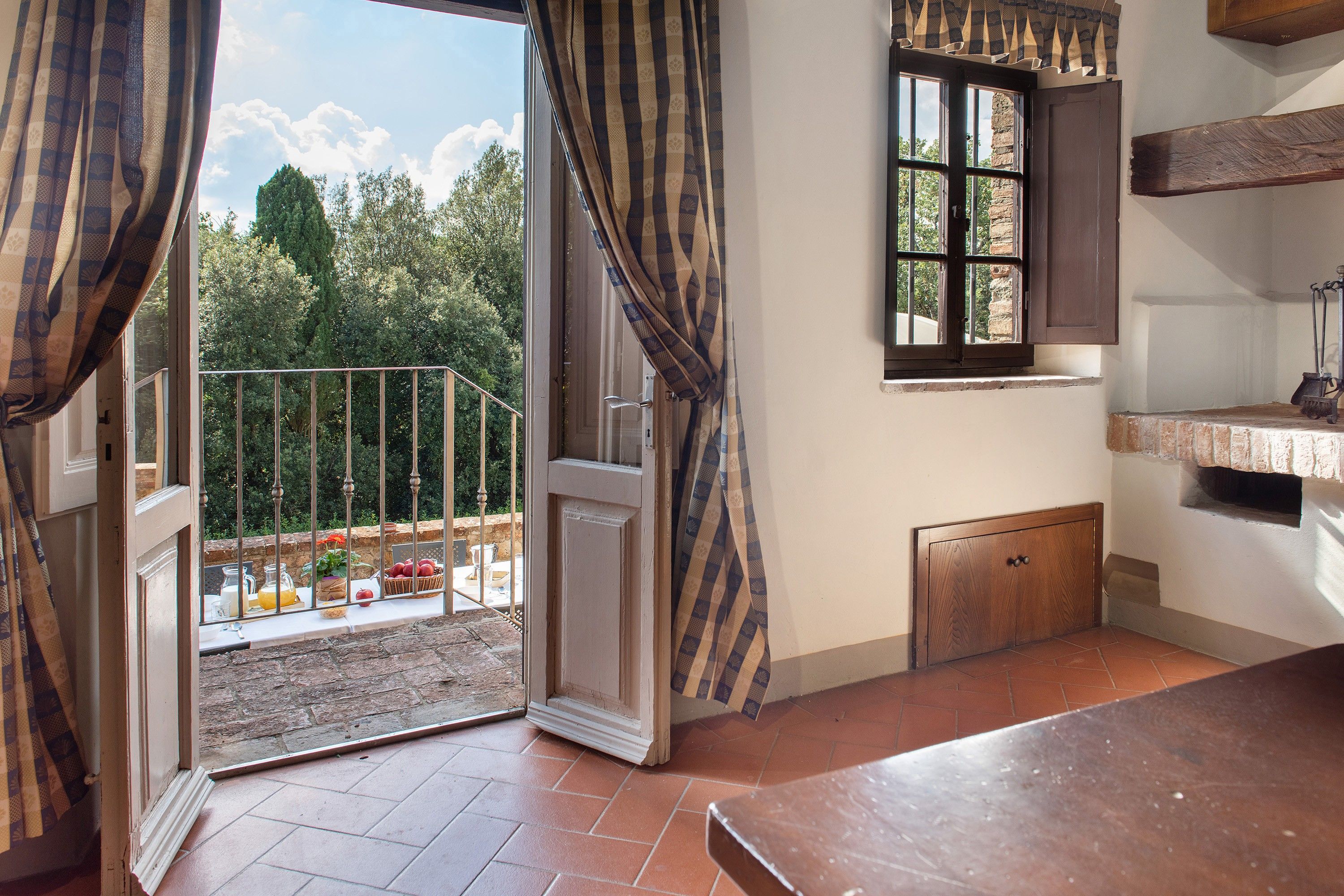 Quarto com porta de vidro deslizante que dá para uma varanda, janela e armário de madeira.