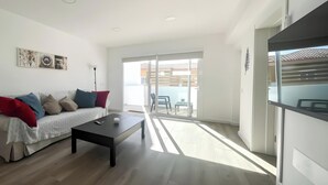 A modern living room with a sofa, coffee table, and artwork on the wall. - B-Rent La Azotea Zen – Your Relaxing Oasis in Corralejo (Corralejo)