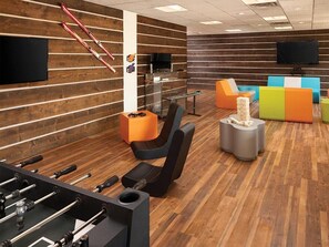 A modern indoor space with a foosball table, comfortable seating, and a television. - 1 Bedroom Villa at Marriott Mountain Valley Lodge (Breckenridge)