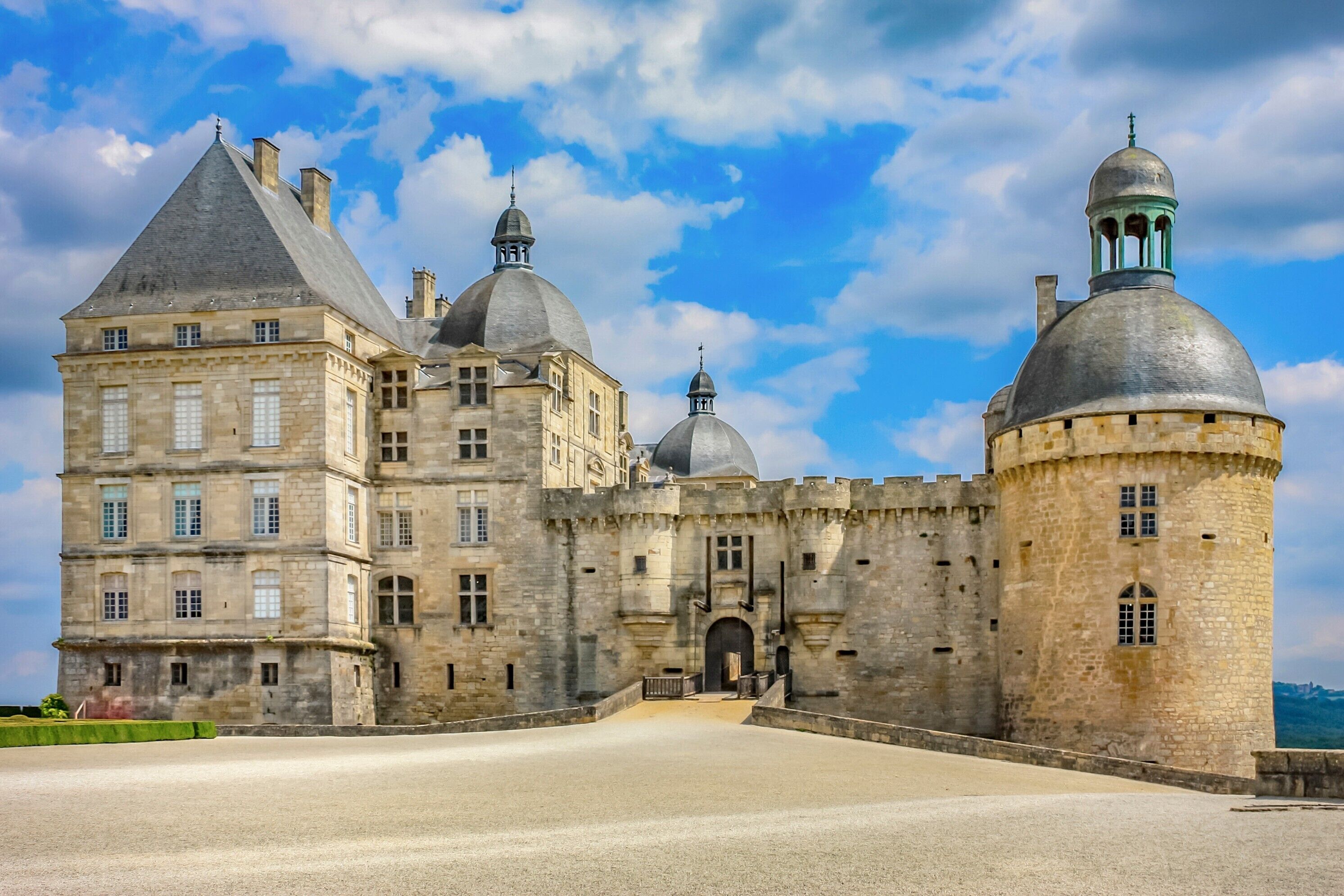 A historic stone castle with multiple towers and a large courtyard.