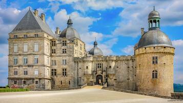 A historic stone castle with multiple towers and a large courtyard.