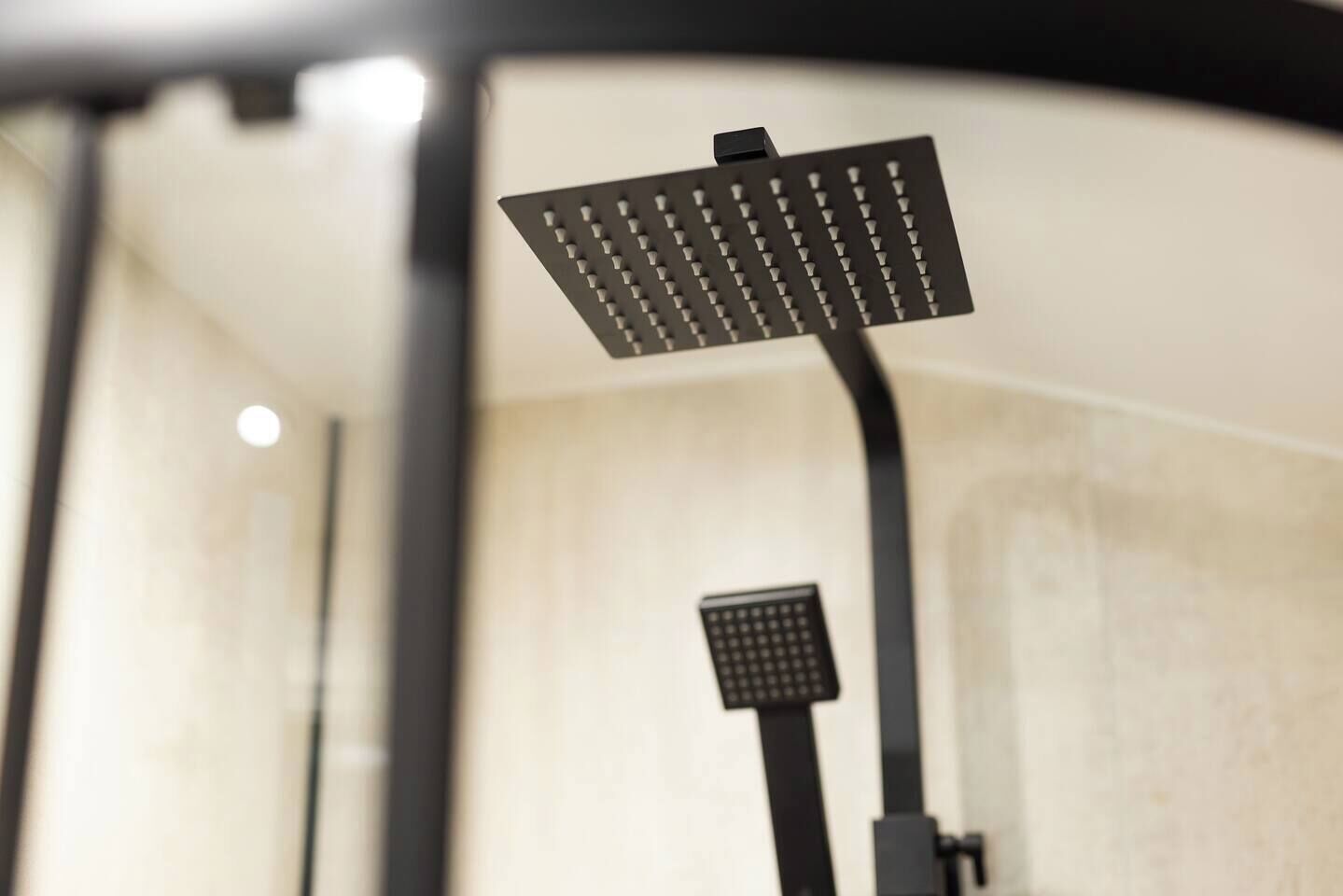 A modern showerhead with a square design and multiple nozzles.