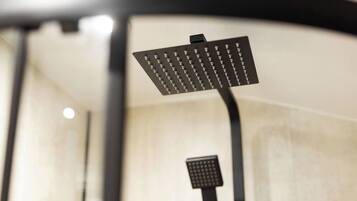 A modern showerhead with a square design and multiple nozzles.