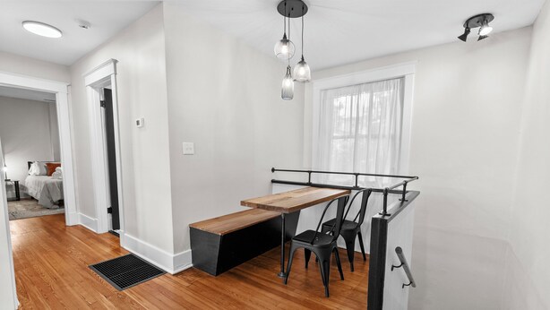 A modern interior with a wooden dining table, black chairs, and a bench. - Charming Garden Home in Old Louisville (Louisville)