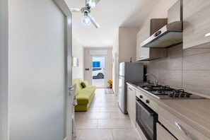 Uma cozinha moderna com fogão a gás, forno e micro-ondas embutido.