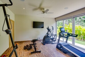 A home gym with a treadmill, elliptical, and weight bench. - Luxury 8BR Villa Hacienda  Punta Cana (Punta Cana)
