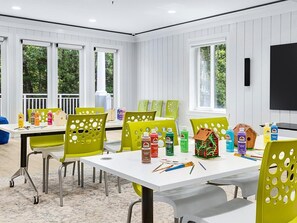 A room with a white table, green chairs, and various art supplies. - 2 Bedroom Villa Beach Access at SurfWatch Resort (Hilton Head Island)