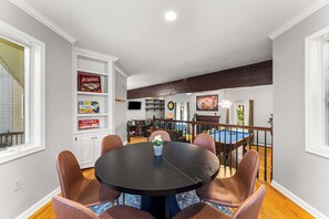 A dining area with a round table and chairs, a pool table, and a television in the background. - 6BR, Sleeps 16, Game Room, Hot Tub, Resort Access (Albrightsville)