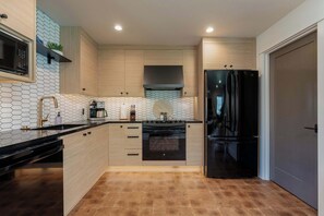 A modern kitchen with a microwave, stove, and refrigerator. - High-end Lakefront Condo B6 Wapato Point Chelan (Manson)