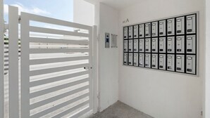 A white door with horizontal slats, a wall-mounted mailbox, and a doorbell. - Apartment 'U Gnore - Polpo Room' with Sea View, Wi-Fi and Air Conditioning (Bari)