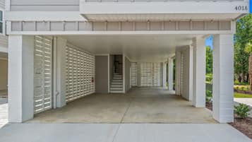 A covered driveway leading to a building with a number 401A.