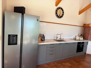 A kitchen with a stainless steel refrigerator, a sink, and a clock on the wall. - Exclusive Retreat Villa Split - Heated pool with Hydrolysis system (no chlorine) (Solin)