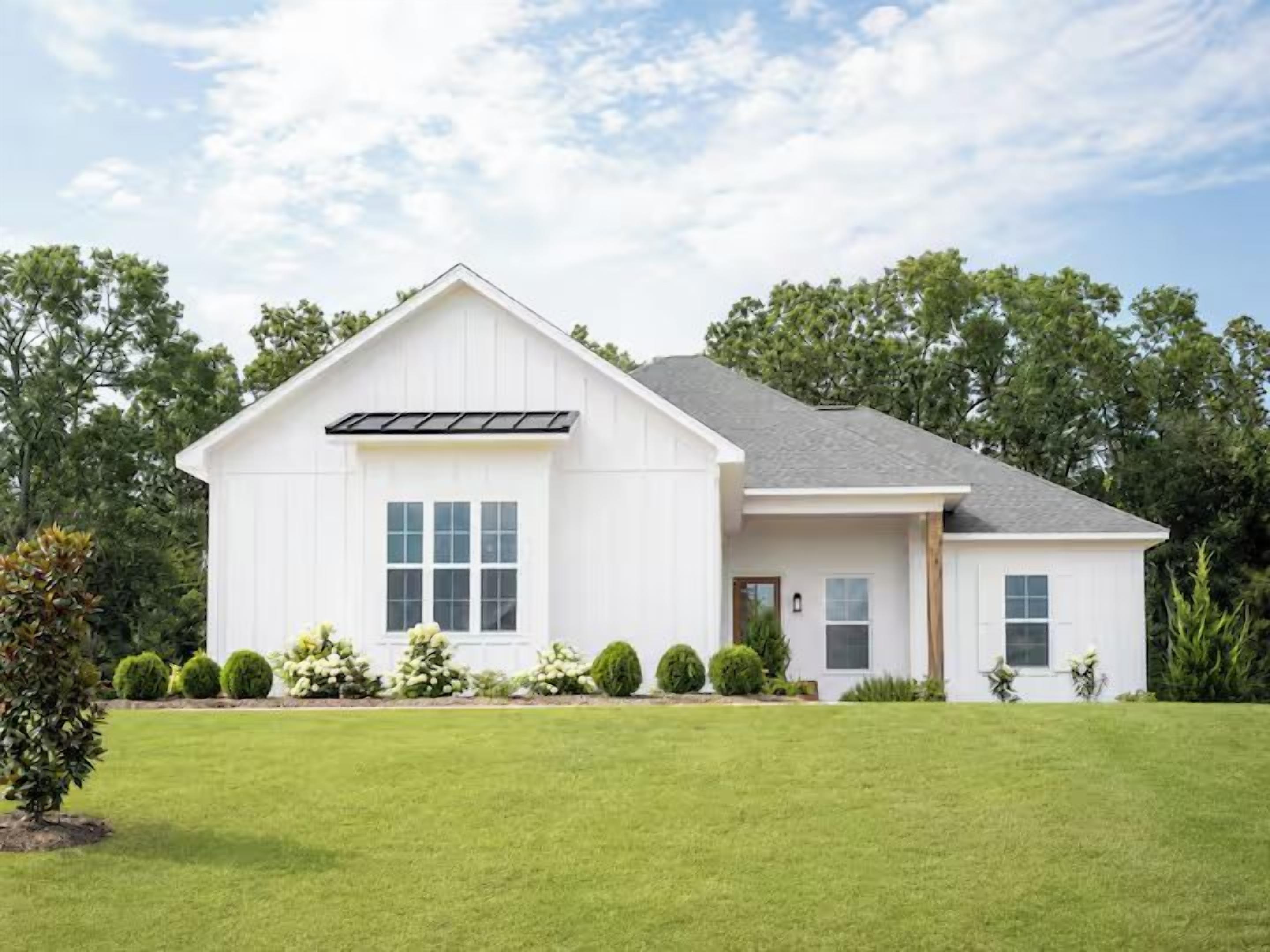 A single-story house with a gabled roof, a front porch, and a well-maintained lawn.