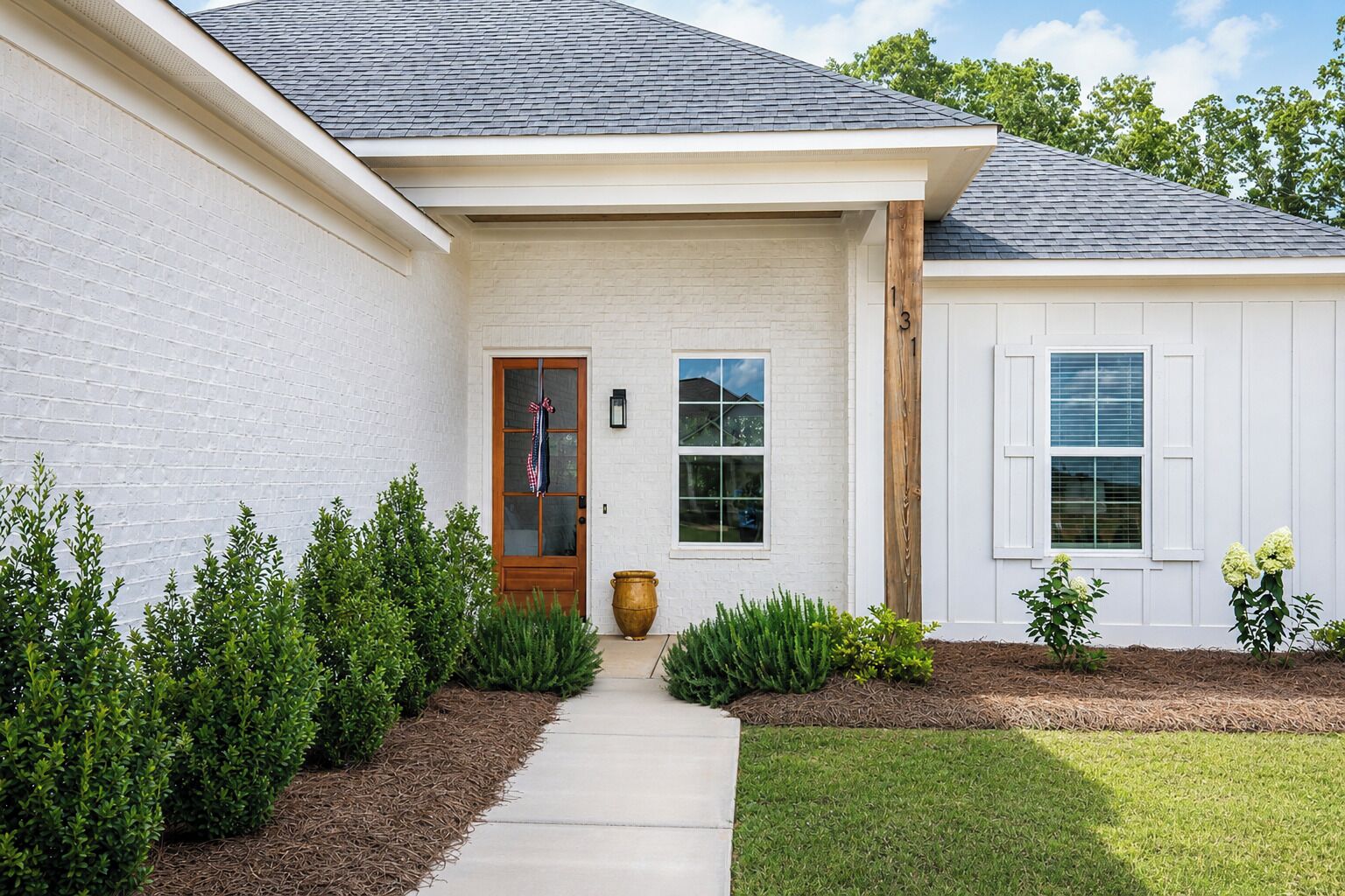 A single-story house with a front door, a window, and a mailbox.