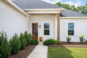 A single-story house with a front door, a window, and a mailbox. - The Merion, 3BR+Game room by Velvet Ditch Villas (Oxford)