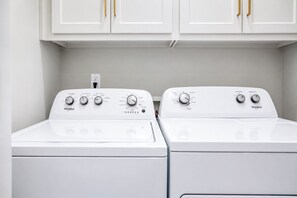 A laundry area with two Whirlpool dryers and white cabinets above. - The Social, 3mi to SQ + Pool by VelvetDitchVillas (Oxford)